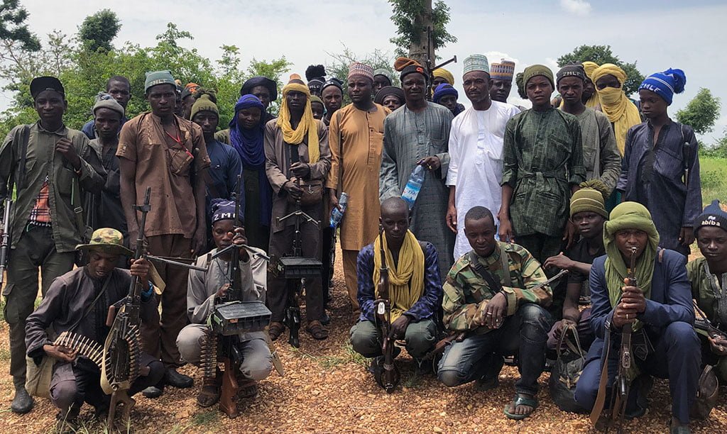 PIC-3-Alhaji-Shingi-center-right-holding-water-and-wearing-fur-cap-and-some-of-his-fighters-photo-by-James-Barnett